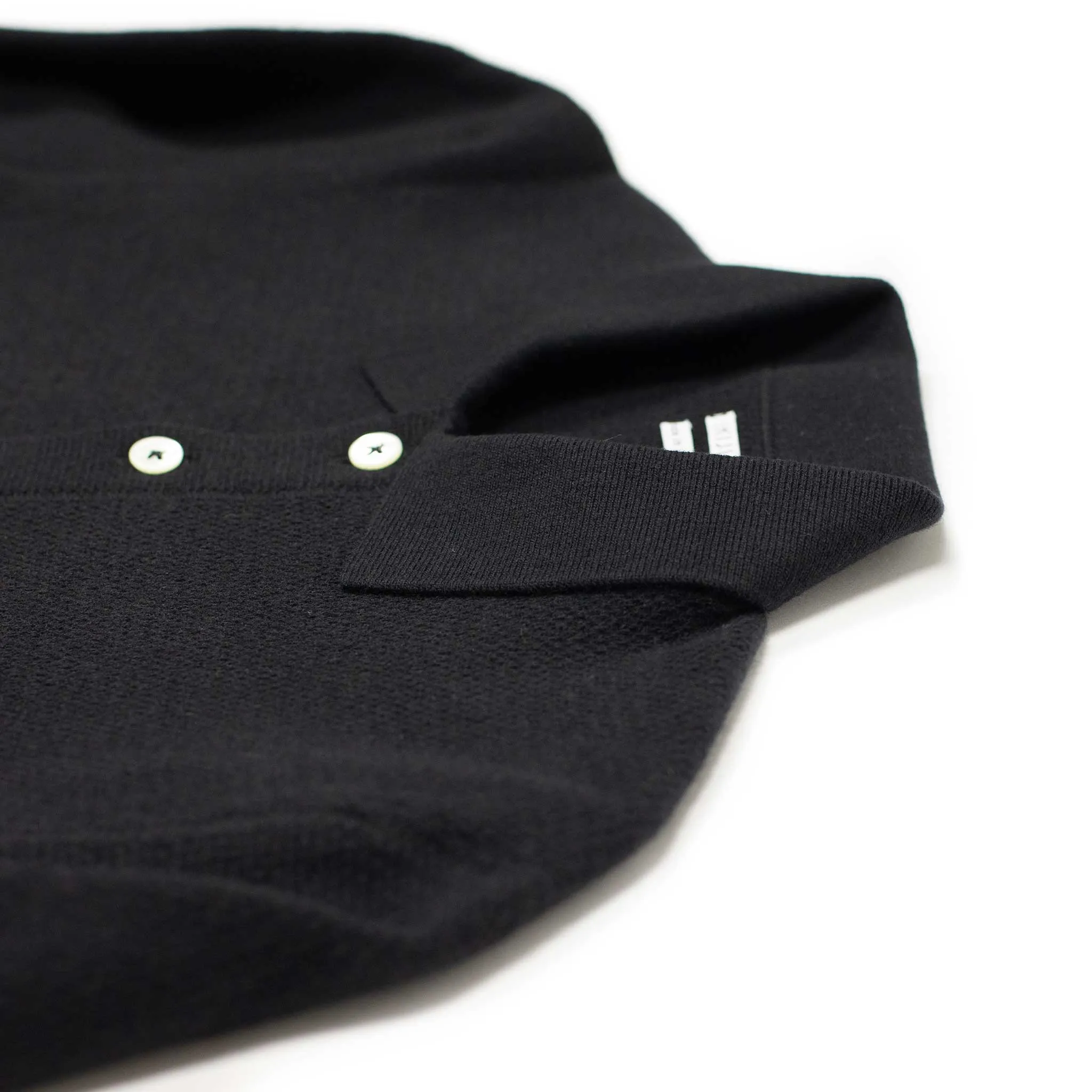 Molded knit long sleeve polo in micro-honeycomb black melange wool